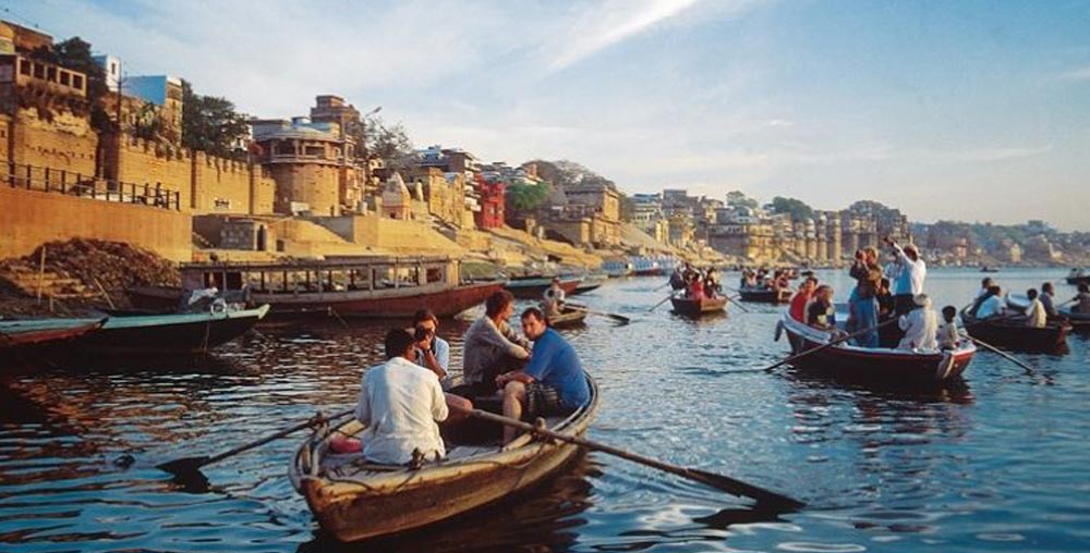 Experience a languid boat ride alongside the bustling ghats of Varanasi
